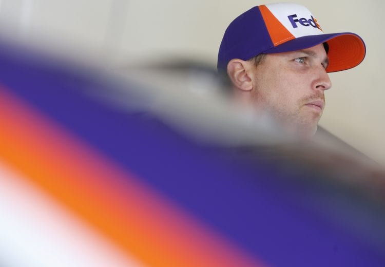 DAYTONA BEACH, FLORIDA - FEBRUARY 08: Denny Hamlin, driver of the #11 FedEx Express Toyota, stands in the garage area during practice for the NASCAR Cup Series Busch Clash at Daytona International Speedway on February 08, 2020 in Daytona Beach, Florida. (Photo by Brian Lawdermilk/Getty Images) | Getty Images