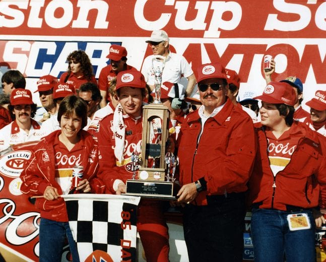 DAYTONA BEACH, FL — February 17, 1985:  Driver Bill Elliott and his car owner Harry Melling are joined by Melling’s sons Matt (far left) and Mark (far right) after Elliott won the Daytona 500 NASCAR Cup race at Daytona International Speedway.  (Photo by ISC Images & Archives via Getty Images)