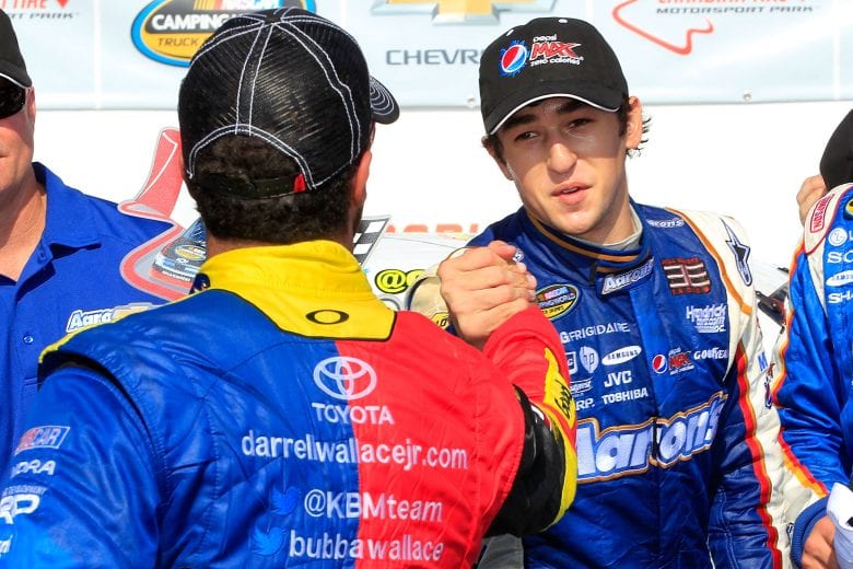 BOWMANVILLE, ON - SEPTEMBER 1: Chase Elliott ( r ), driver of the #94 Aaron's Dream Machine/Hendrickcars.com Chevrolet, is congratulated by Darrell Wallace Jr. ( l ), driver of the #54 Camping World/Good Sam Toyota, in victory lane after winning the NASCAR Camping World Truck Series Chevrolet Silverado 250 at Canadian Tire Motorsport Park on September 1, 2013 in Bowmanville, Canada. (Photo by Geoff Burke/NASCAR via Getty Images)
