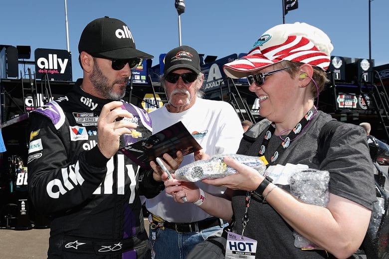 AVONDALE, ARIZONA - MARCH 06: Jimmie Johnson, driver of the #48 Ally Chevrolet, signs autographs for fans during practice for the NASCAR Cup Series FanShield 500 at Phoenix Raceway on March 06, 2020 in Avondale, Arizona. (Photo by Christian Petersen/Getty Images) | Getty Images