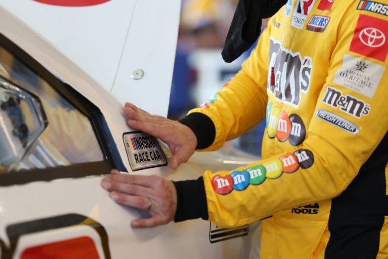 AVONDALE, ARIZONA - MARCH 06: Kyle Busch, driver of the #18 Sport Clips Toyota, puts a decal on his car during practice for the NASCAR Cup Series FanShield 500 at Phoenix Raceway on March 06, 2020 in Avondale, Arizona. (Photo by Chris Graythen/Getty Images) | Getty Images