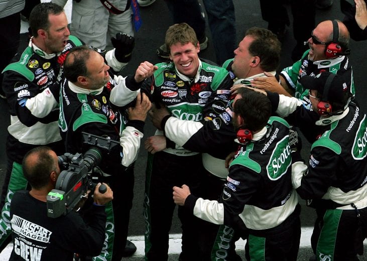 HAMPTON, GA - MARCH 20:  Carl Edwards, driver of the #99 Roush Racing Ford, is congratulated by teammates after winning the NASCAR Nextel Cup Golden Corral 500 on March 20, 2005 at the Atlanta Motor Speedway in Hampton, Georgia.  (Photo by Jamie Squire/Getty Images) | Getty Images