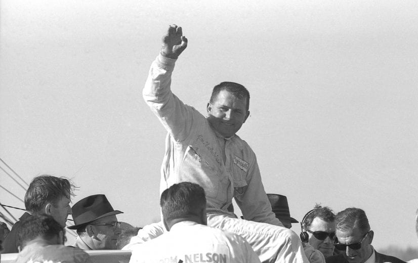 HAMPTON, GA - MARCH 27:  Driver Jim Hurtubise waves after winning the Atlanta 500 race on March 27, 1966 at the Atlanta International Raceway in Hampton, Georgia. Hurtubise has malformed hands that had been shaped by doctors, after an earlier accident, to allow him to hold the wheel of a race car. This was Hurtubise's only career win. (Photo by Howard O'Reilly/Dozier Mobley/Getty Images)