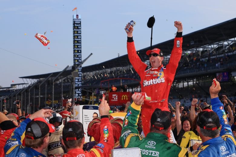 INDIANAPOLIS, IN - JULY 24:  Kyle Busch, driver of the #18 Skittles Toyota, celebrates in victory lane after winning the NASCAR Sprint Cup Series Crown Royal Presents the Combat Wounded Coalition 400 at Indianapolis Motor Speedway on July 24, 2016 in Indianapolis, Indiana.  (Photo by Daniel Shirey/Getty Images) | Getty Images