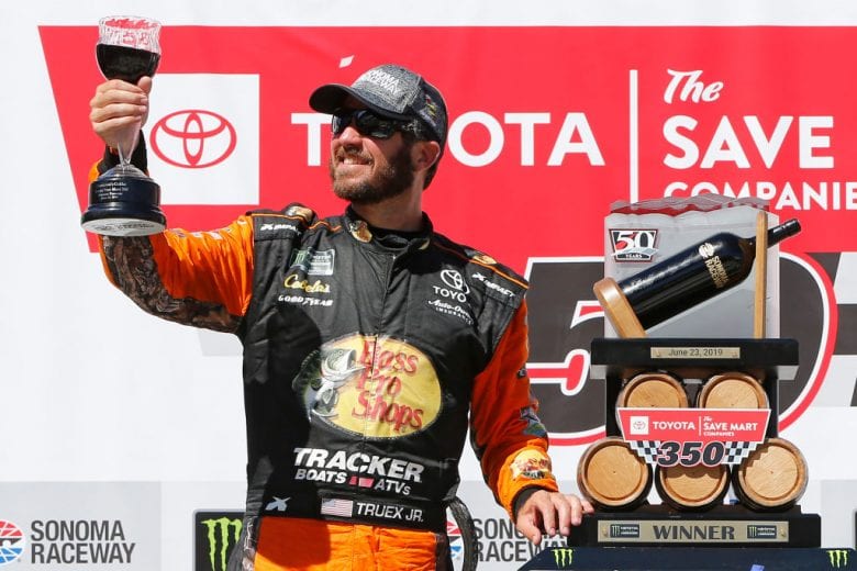 SONOMA, CALIFORNIA - JUNE 23: Martin Truex Jr., driver of the #19 Bass Pro Shops Toyota, poses with the trophy in Victory Lane after winning the Monster Energy NASCAR Cup Series Toyota/Save Mart 350 at Sonoma Raceway on June 23, 2019 in Sonoma, California. (Photo by Jonathan Ferrey/Getty Images) | Getty Images