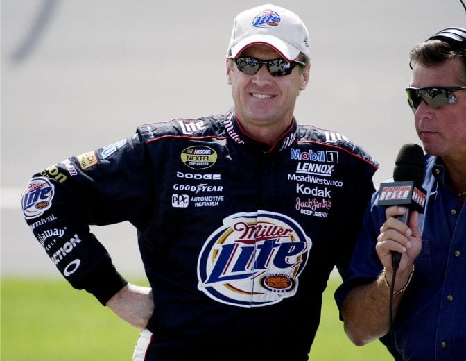 Rusty Wallace talks with a reporter before his qualifying attempt for the NASCAR Nextel Cup DHL 400 at Michigan International Speedway in Brooklyn, Mich., Friday, June 18, 2004. Wallace will start tenth in  Sunday's race. (Photo by Gregory Shamus/Getty Images)