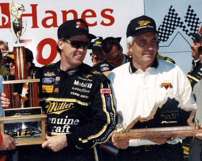 MARTINSVILLE, VA — April 24, 1994:  Driver Rusty Wallace (L) and his car owner Roger Penske (R) receive their trophies in victory lane at Martinsville Speedway after Wallace won the Hanes 500 NASCAR Cup race.  (Photo by ISC Images & Archives via Getty Images)