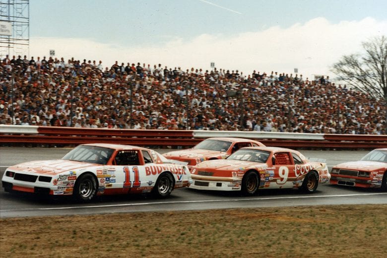 RICHMOND, VA — 1986: Darrell Waltrip (No. 11) leads Bill Elliott (No. 9) during a NASCAR Cup race at Richmond International Raceway. (Photo by ISC Images & Archives via Getty Images)