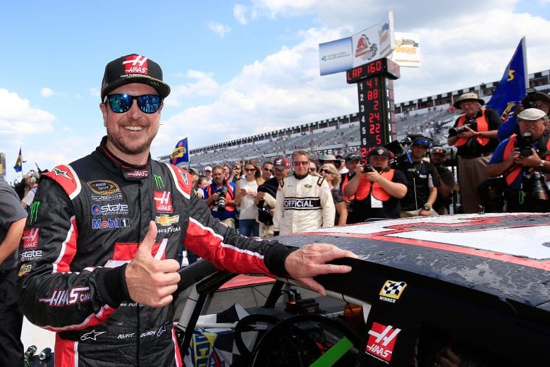LONG POND, PA - JUNE 06:  Kurt Busch, driver of the #41 Monster Energy/Haas Automation Chevrolet, poses with the winner's decal on his car in Victory Lane after winning the NASCAR Sprint Cup Series Axalta 