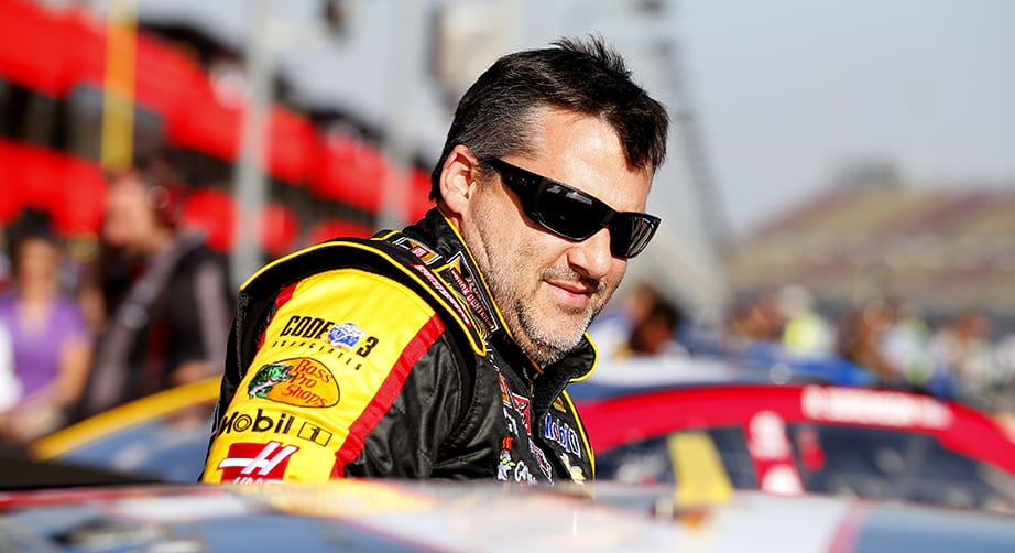 FONTANA, CA - MARCH 20:  Tony Stewart, driver of the #14 Rush Truck Centers/ Mobil 1 Chevrolet, climbs into his car prior to qualifying for the NASCAR Sprint Cup Series Auto Club 400 at Auto Club Speedway on March 20, 2015 in Fontana, California.  (Photo by Matt Sullivan/NASCAR via Getty Images)