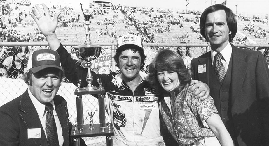 BRISTOL, TN - APRIL 2, 1978: Darrell Waltrip wasn't always the easiest on his crew members, but heaped mounds of praise on them after winning the Southeastern 500 at Bristol in 1978. Pictured are Waltrip (C), Bristol president & GM Lanny Hester (L), Darrell's wife Stevie, and track VP Gary Baker. (Photo by ISC Archives/CQ-Roll Call Group via Getty Images)