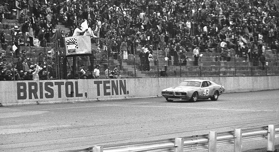 BRISTOL, TN - MARCH 16, 1975: Richard Petty takes the checkered flag to win the Southeastern 500 NASCAR Cup race at Bristol International Speedway. Petty led 243 of the 500 laps and finished up six laps on the field in taking the victory. (Photo by ISC Images & Archives via Getty Images)