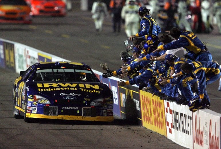 PHOENIX - APRIL 23: Kurt Busch celebrates by driving his #97 Irwin Industrial Tools Ford by his crew after winning the NASCAR Nextel Cup Series Subway Fresh 500 on April 23, 2005 at the Phoenix International Speedway in Phoenix, Arizona. (Photo by Jeff Gross/Getty Images) | Getty Images
