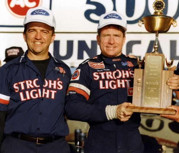 ROCKINGHAM, NC - OCTOBER 22: Driver Mark Martin holds his trophy in Victory Lane with car owner Jack Roush after his first career Winston Cup victory at the AC Delco 500 race on October 22, 1989 at the North Carolina Motor Speedway in Rockingham, North Carolina. (Photo by Dozier Mobley/Getty Images)