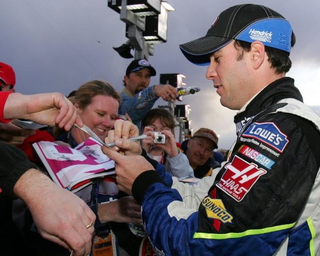 Jimmie Johnson, driver of the #48 Lowe's Chevrolet, signs autographs after he finished with third at todays time trials at the Las Vegas Motor Speedway. March 10, 2006 (Photo by Warren Wimmer/Getty Images)