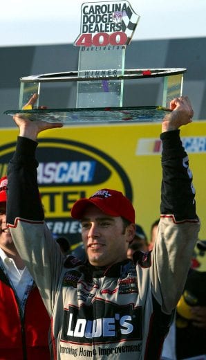 DARLINGTON, SC - MARCH 21: Jimmie Johnson, driver of the #48 Lowe's Chevrolet Monte Carlo, celebrates winning the Carolina Dodge Dealers 400 with the trophy at the Darlington Motorspeedway on March 21, 2004 in Darlington, South Carolina. (Photo By: Donald Miralle/Getty Images) | Getty Images