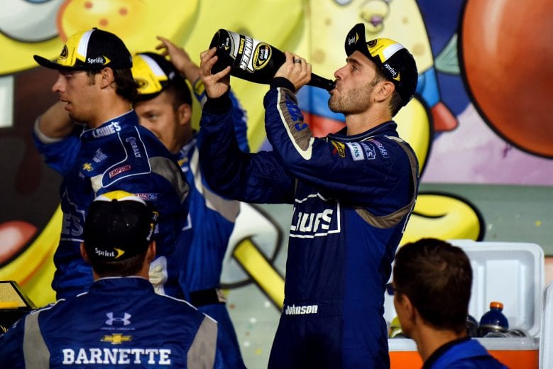 KANSAS CITY, KS - MAY 09: Jimmie Johnson, driver of the #48 Lowe's Chevrolet, celebrates with champagne in Victory Lane after winning the NASCAR Sprint Cup Series SpongeBob SquarePants 400 at Kansas Speedway on May 9, 2015 in Kansas City, Kansas. (Photo by Jonathan Moore/NASCAR via Getty Images)