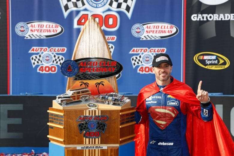 FONTANA, CA - MARCH 20: Jimmie Johnson, driver of the #48 Lowe's / Superman Chevrolet, poses with the winners trophy after winning the NASCAR Sprint Cup Series Auto Club 400 at Auto Club Speedway on March 20, 2016 in Fontana, California. (Photo by Jeff Zelevansky/NASCAR via Getty Images)