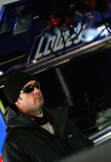 DAYTONA, FL - JANUARY 18: Jimmie Johnson, driver of the #48 Lowes Chevrolet, stands in the garage during Nascar Nextel Cup testing, on January 18, 2005 at Daytona International Speedway in Daytona, Florida. (Photo by Streeter Lecka/Getty Images) | Getty Images