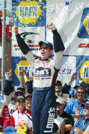 28 Apr 2002: Gordon Racing driver Jimmie Johnson celebrates in victory lane after winning the NASCAR Winston Cup Series NAPA Auto Parts 500 at the California Speedway in Fontana, California. DIGITAL IMAGE. Mandatory Credit: Robert Laberge/Getty Images.