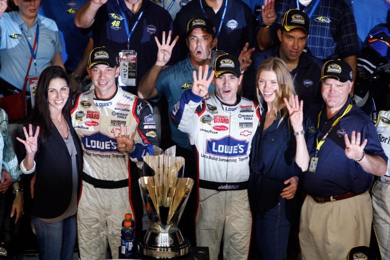HOMESTEAD, FL - NOVEMBER 22: (2nd L) Crew chief Chad Knaus, (L) girlfriend Lisa Rockelmann, Jimmie Johnson (C), driver of the #48 Lowe's Chevrolet, poses with his wife (2nd R) Chandra after winning the NASCAR Sprint Cup Series Championship after finishing in fifth place in the Ford 400 at Homestead-Miami Speedway on November 22, 2009 in Homestead, Florida. Johnson becomes the first driver in the history of NASCAR to win four consecutive championships since the sports inception in 1949.during the NASCAR Sprint Cup Series Ford 400 at Homestead-Miami Speedway on November 22, 2009 in Homestead, Florida. (Photo by Chris Graythen/Getty Images) | Getty Images