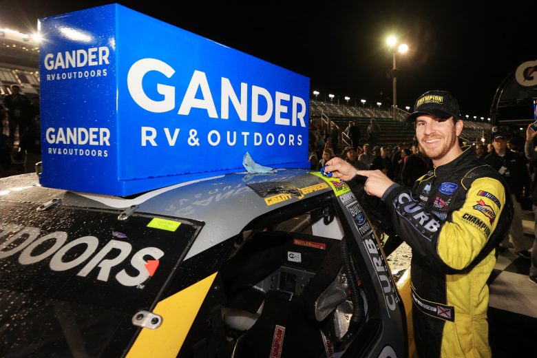 DAYTONA BEACH, FLORIDA - FEBRUARY 14: Grant Enfinger, driver of the #98 Champion/Curb Records Ford, affixes the winner's decal on his car in Victory Lane after winning the NASCAR Gander RV & Outdoors Truck Series NextEra Energy 250 at Daytona International Speedway on February 14, 2020 in Daytona Beach, Florida. (Photo by Chris Graythen/Getty Images) | Getty Images