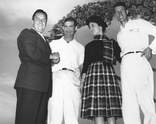 CHARLOTTE, NC - OCTOBER 16, 1960: Speedy Thompson (2nd from left) won the second race conducted at the brand new Charlotte Motor Speedway, the National 400. He was driving the Wood Bros. Ford. Car owner Glen Wood is at right. (Photo by ISC Archives/CQ-Roll Call Group via Getty Images)