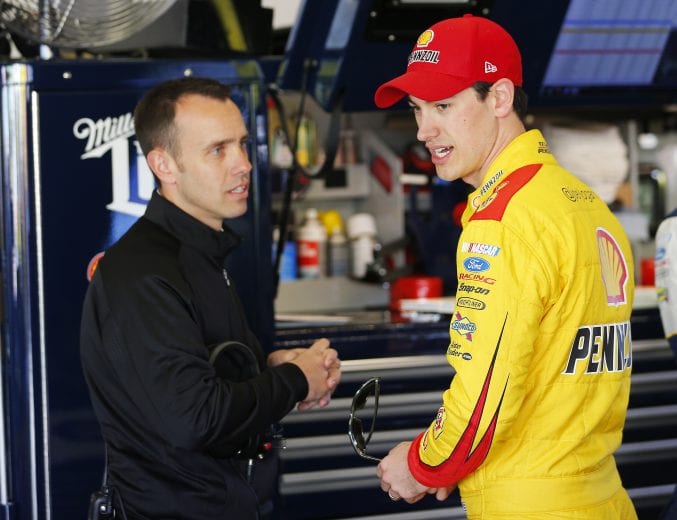 DAYTONA BEACH, FL - FEBRUARY 18:  Joey Logano, driver of the #22 Shell Pennzoil Ford, right, talks with Paul Wolfe, crew chief of the #2 Miller Lite Ford, in the garage area during practice for the 57th Annual Daytona 500 at Daytona International Speedway on February 18, 2015 in Daytona Beach, Florida.  (Photo by Chris Trotman/NASCAR via Getty Images)