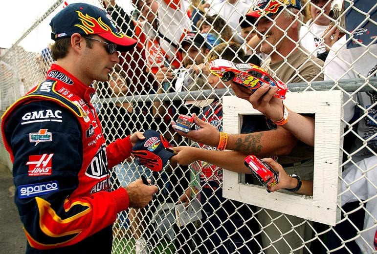 LONG POND, PA - JULY 26: Jeff Gordon, driver of the #24 Hendrick Motorsports Chevrolet Monte Carlo, signs autographs during qualifying for the NASCAR Winston Cup Series Pennsylavania 500 on July 26, 2002 at Pocono Raceway in Long Pond, Pennsylvania. (Photo by Jamie Squire/Getty Images) | Getty Images