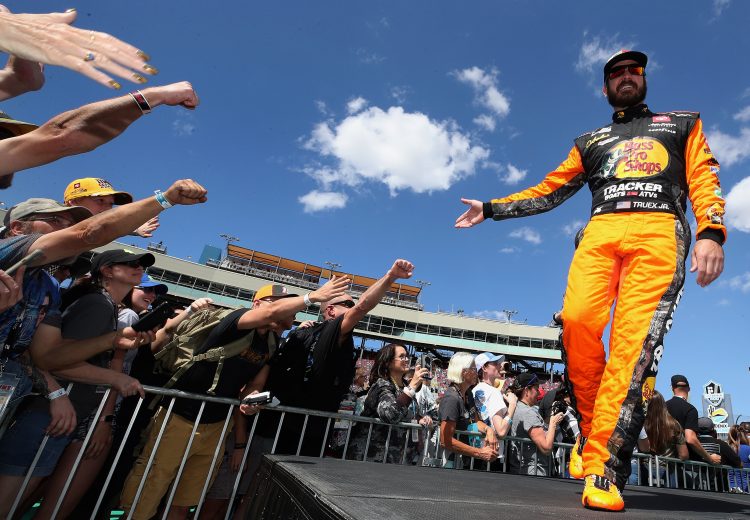 AVONDALE, ARIZONA - MARCH 08: Martin Truex Jr., driver of the #19 Bass Pro Shops Toyota, waves to fans as he is introduced before the NASCAR Cup Series FanShield 500 at Phoenix Raceway on March 08, 2020 in Avondale, Arizona. (Photo by Christian Petersen/Getty Images) | Getty Images