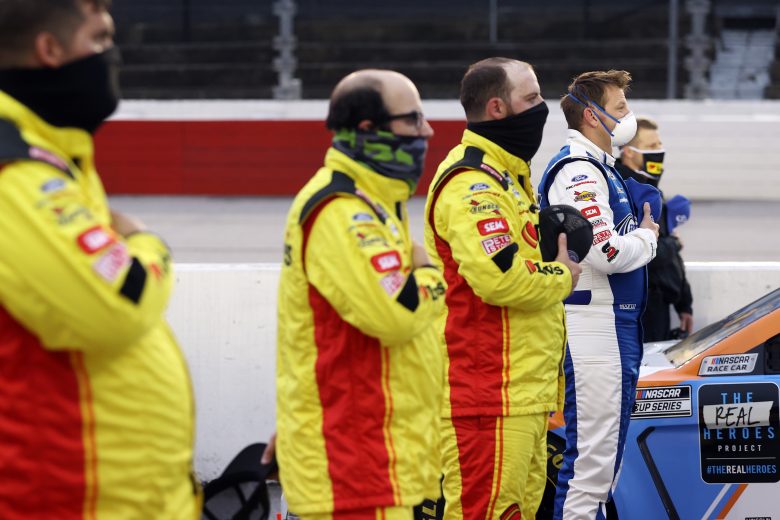 DARLINGTON, SOUTH CAROLINA - MAY 20: Matt DiBenedetto, driver of the #21 Motorcraft/Quick Lane Ford,      stands on the grid during the national anthem prior to the NASCAR Cup Series Toyota 500 at Darlington Raceway on May 20, 2020 in Darlington, South Carolina. (Photo by Chris Graythen/Getty Images) | Getty Images