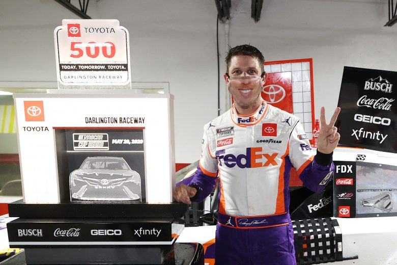 DARLINGTON, SOUTH CAROLINA - MAY 20: Denny Hamlin, driver of the #11 FedEx Delivering Strength Toyota, celebrates in Victory Lane after winning the rain-delayed NASCAR Cup Series Toyota 500 at Darlington Raceway on May 20, 2020 in Darlington, South Carolina. (Photo by Chris Graythen/Getty Images) | Getty Images