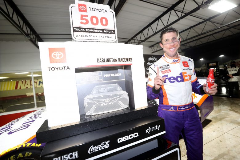 DARLINGTON, SOUTH CAROLINA - MAY 20: Denny Hamlin, driver of the #11 FedEx Delivering Strength Toyota, celebrates in Victory Lane after winning the rain-delayed NASCAR Cup Series Toyota 500 at Darlington Raceway on May 20, 2020 in Darlington, South Carolina. (Photo by Chris Graythen/Getty Images) | Getty Images