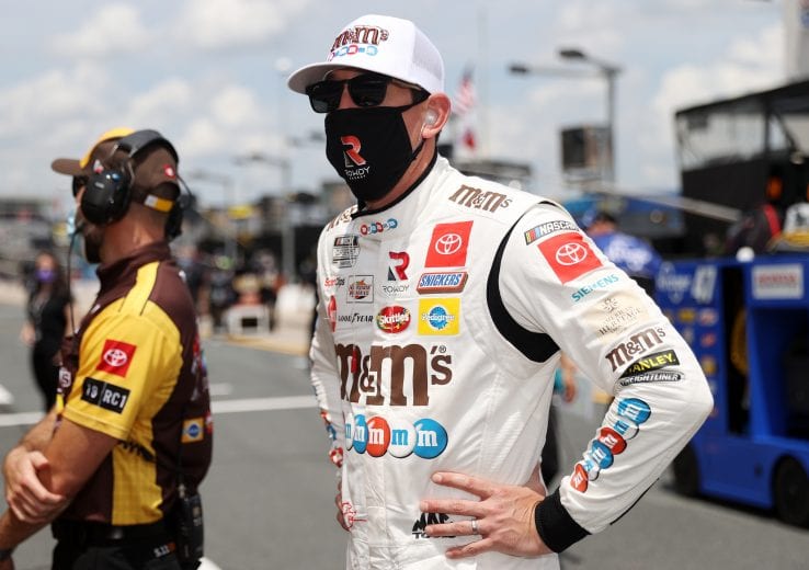 CONCORD, NORTH CAROLINA - MAY 24: Kyle Busch, driver of the #18 M&M's Red White Blue Toyota, stands on the grid during qualifying for the NASCAR Cup Series Coca-Cola 600 at Charlotte Motor Speedway on May 24, 2020 in Concord, North Carolina. (Photo by Chris Graythen/Getty Images) | Getty Images