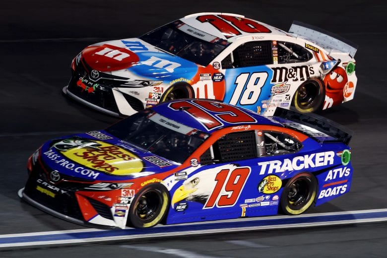 CONCORD, NORTH CAROLINA - MAY 24: Martin Truex Jr., driver of the #19 Bass Pro Shops/TRACKER/USO Toyota, leads Kyle Busch, driver of the #18 M&M's Red White Blue Toyota, during the NASCAR Cup Series Coca-Cola 600 at Charlotte Motor Speedway on May 24, 2020 in Concord, North Carolina. (Photo by Chris Graythen/Getty Images) | Getty Images