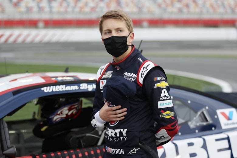 CONCORD, NORTH CAROLINA - MAY 24: William Byron, driver of the #24 Liberty University Patriotic Chevrolet, stands on pit road during the national anthem prior to the NASCAR Cup Series Coca-Cola 600 at Charlotte Motor Speedway on May 24, 2020 in Concord, North Carolina. (Photo by Chris Graythen/Getty Images) | Getty Images