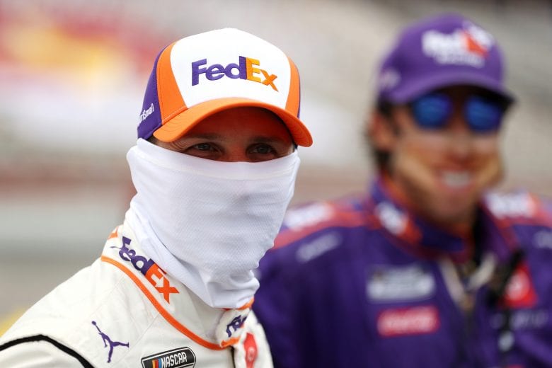 CONCORD, NORTH CAROLINA - MAY 24: Denny Hamlin, driver of the #11 FedEx SupportSmall Toyota, stands on the grid prior to the NASCAR Cup Series Coca-Cola 600 at Charlotte Motor Speedway on May 24, 2020 in Concord, North Carolina. (Photo by Chris Graythen/Getty Images) | Getty Images