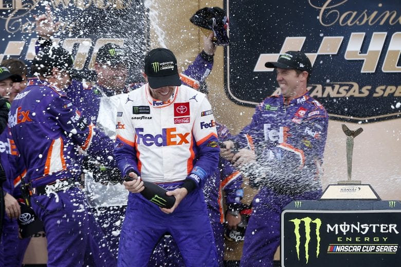 KANSAS CITY, KANSAS - OCTOBER 20: Denny Hamlin, driver of the #11 FedEx Office Toyota, celebrates in Victory Lane after winning the Monster Energy NASCAR Cup Series Hollywood Casino 400 at Kansas Speedway on October 20, 2019 in Kansas City, Kansas. (Photo by Brian Lawdermilk/Getty Images) | Getty Images