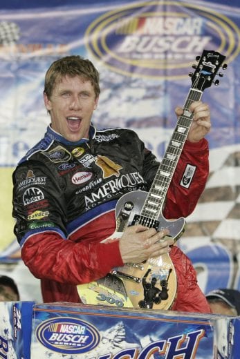 LEBANON, TN - JUNE 10: Carl Edwards, driver of the #60 Ameriquest Mortgage Ford, celebrates with the winner's guitar after winning the NASCAR Busch Series Federated Auto Parts 300 at the Nashville Superspeedway on June 10, 2006 in Lebanon, Tennessee. (Photo by Todd Warshaw/Getty Images For NASCAR) | Getty Images