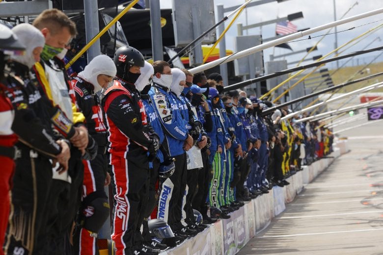 HAMPTON, GEORGIA - JUNE 07: Crew members pause and stand on pit wall for a moment of listening in reflection of recent social unrest prior to the NASCAR Cup Series Folds of Honor QuikTrip 500 at Atlanta Motor Speedway on June 07, 2020 in Hampton, Georgia. (Photo by Chris Graythen/Getty Images) | Getty Images