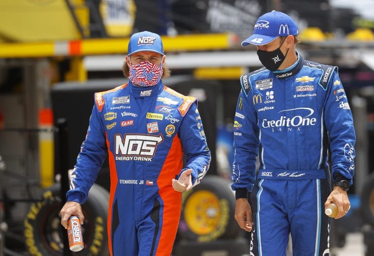 HAMPTON, GEORGIA - JUNE 07: Ricky Stenhouse Jr., driver of the #47 Kroger Chevrolet, and Matt Kenseth, driver of the #42 Credit One Bank Chevrolet, walk the grid prior to the NASCAR Cup Series Folds of Honor QuikTrip 500 at Atlanta Motor Speedway on June 07, 2020 in Hampton, Georgia. (Photo by Chris Graythen/Getty Images) | Getty Images