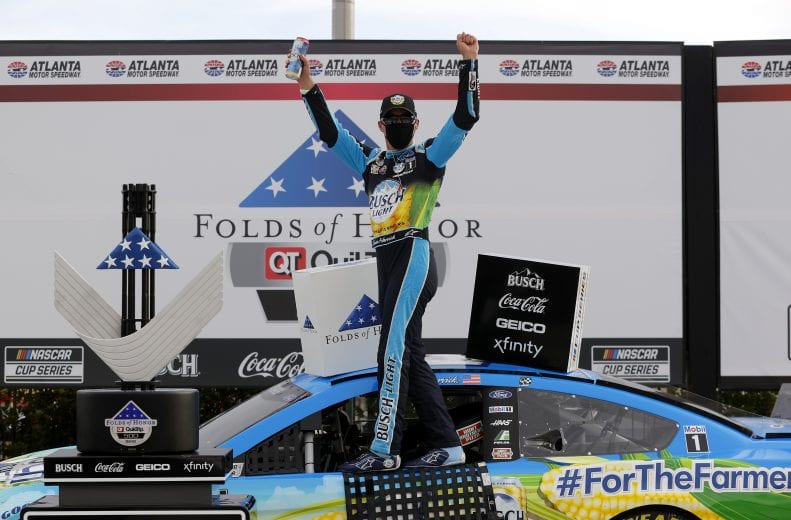 HAMPTON, GEORGIA - JUNE 07: Kevin Harvick, driver of the #4 Busch Light For The Farmers Ford, celebrates in Victory Lane after winning the NASCAR Cup Series Folds of Honor QuikTrip 500 at Atlanta Motor Speedway on June 07, 2020 in Hampton, Georgia. (Photo by Chris Graythen/Getty Images) | Getty Images
