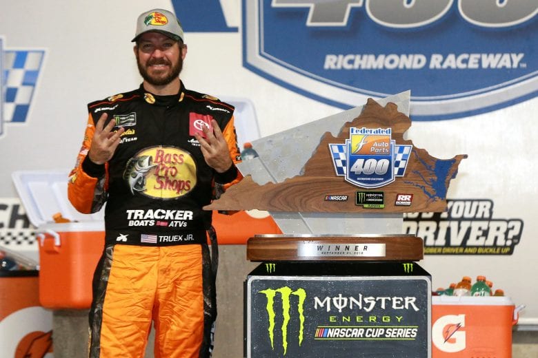 RICHMOND, VIRGINIA - SEPTEMBER 21: Martin Truex Jr., driver of the #19 Bass Pro Shops Toyota, poses with the trophy in Victory Lane after winning the Monster Energy NASCAR Cup Series Federated Auto Parts 400 at Richmond Raceway on September 21, 2019 in Richmond, Virginia. (Photo by Sean Gardner/Getty Images) | Getty Images