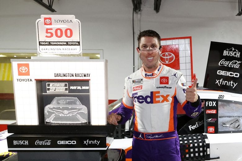 DARLINGTON, SOUTH CAROLINA - MAY 20: Denny Hamlin, driver of the #11 FedEx Delivering Strength Toyota, celebrates in Victory Lane after winning the rain-shortened NASCAR Cup Series Toyota 500 at Darlington Raceway on May 20, 2020 in Darlington, South Carolina. (Photo by Chris Graythen/Getty Images) | Getty Images