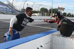 MARTINSVILLE, VIRGINIA - JUNE 10: Bubba Wallace, driver of the #43 Richard Petty Motorsports Chevrolet, wears a "I Can't Breathe - Black Lives Matter" t-shirt under his firesuit in solidarity with protesters around the world taking to the streets after the death of George Floyd on May 25, and Daniel Suarez, driver of the #96 CommScope Toyota, bump fist on the grid prior to the NASCAR Cup Series Blue-Emu Maximum Pain Relief 500 at Martinsville Speedway on June 10, 2020 in Martinsville, Virginia. (Photo by Jared C. Tilton/Getty Images) | Getty Images