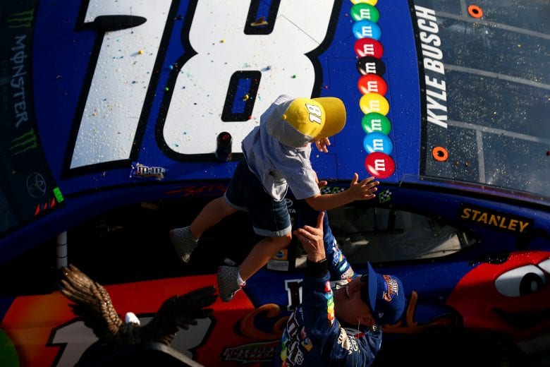 LONG POND, PA - JULY 29: Kyle Busch, driver of the #18 M&M's Caramel Toyota, celebrates with his son, Brexton, in Victory Lane after winning the Monster Energy NASCAR Cup Series Gander Outdoors 400 at Pocono Raceway on July 29, 2018 in Long Pond, Pennsylvania. (Photo by Sarah Crabill/Getty Images) | Getty Images