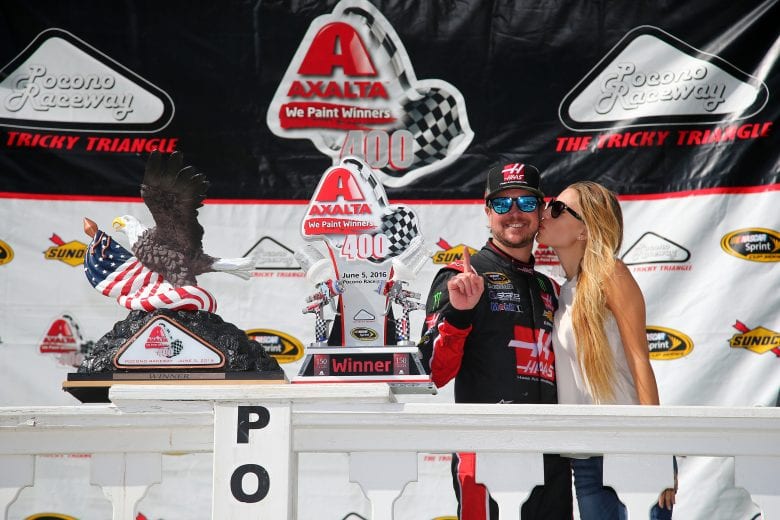 LONG POND, PA - JUNE 06: Kurt Busch, driver of the #41 Monster Energy/Haas Automation Chevrolet, and his girlfriend Ashley Van Metre pose in Victory Lane after winning the NASCAR Sprint Cup Series Axalta