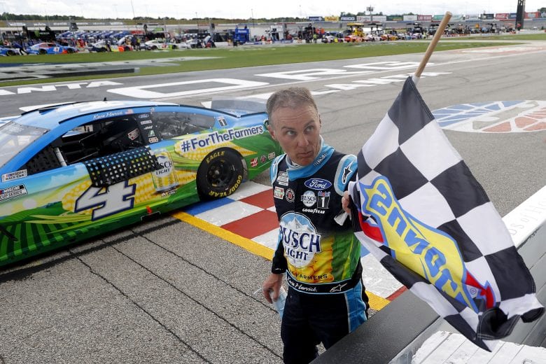 HAMPTON, GEORGIA - JUNE 07: Kevin Harvick, driver of the #4 Busch Light For The Farmers Ford, takes the checkered flag to celebrate winning the NASCAR Cup Series Folds of Honor QuikTrip 500 at Atlanta Motor Speedway on June 07, 2020 in Hampton, Georgia. (Photo by Kevin C. Cox/Getty Images) | Getty Images