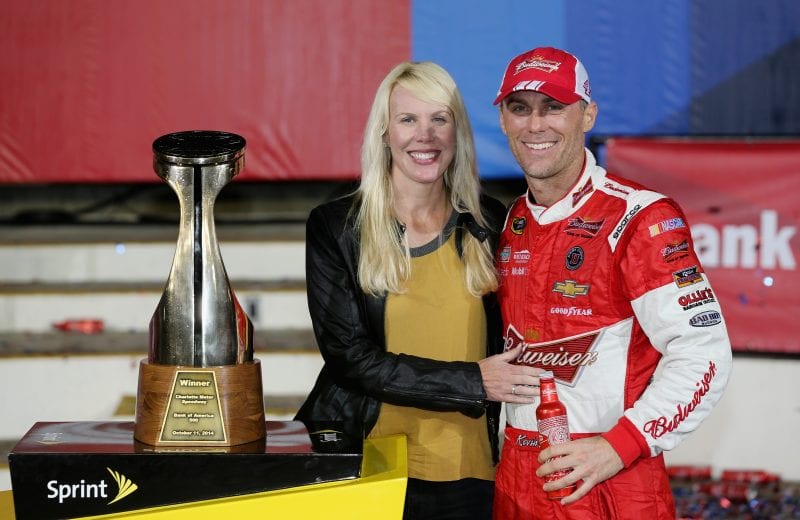 CHARLOTTE, NC - OCTOBER 11:  Kevin Harvick, driver of the #4 Budweiser Chevrolet, right, poses with wife DeLana after winning the NASCAR Sprint Cup Series Bank of America 500 at Charlotte Motor Speedway on October 11, 2014 in Charlotte, North Carolina.  (Photo by Sarah Glenn/Getty Images) | Getty Images