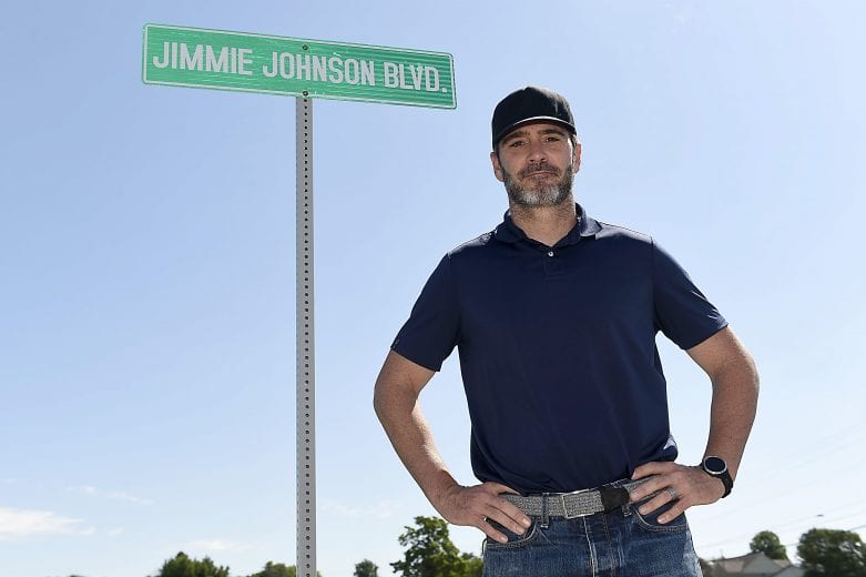 SPARTA, KENTUCKY - JULY 12: Jimmie Johnson, driver of the #48 Ally Chevrolet, stands in front of a street sign renamed